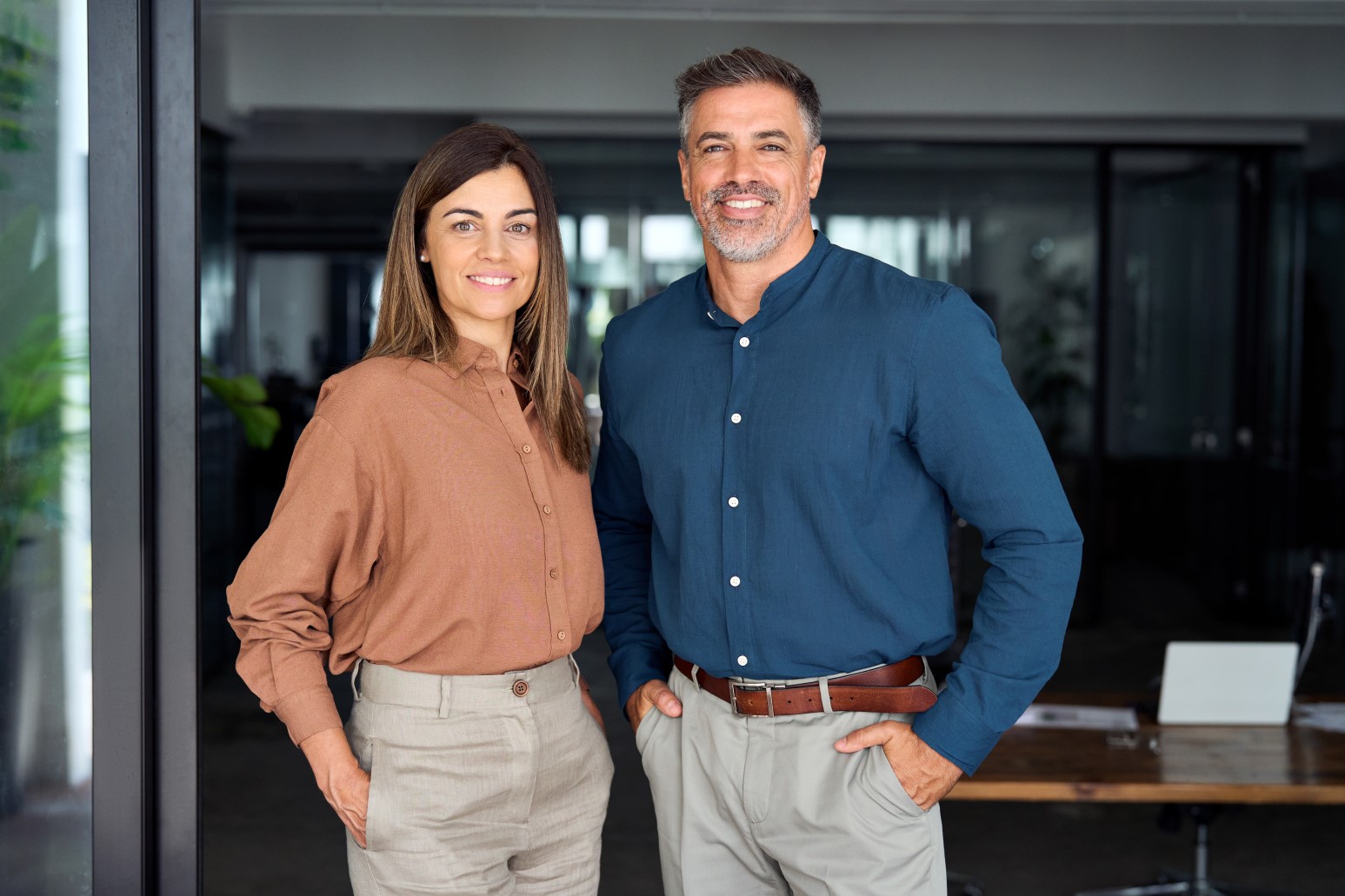 Smiling Latin middle aged business man and woman